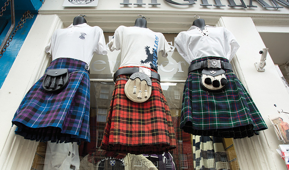 Tartan kilts Three tartan kilts and sweaters hung outside a shop