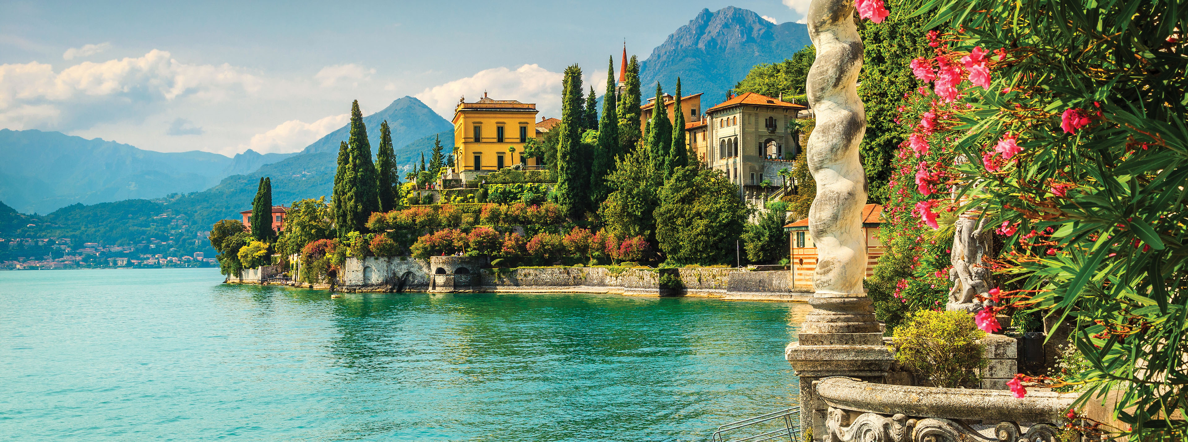 Lake Como from Varenna Italy featuring historic villas, gardens and alpine mountains Lake Como from Varenna Italy
