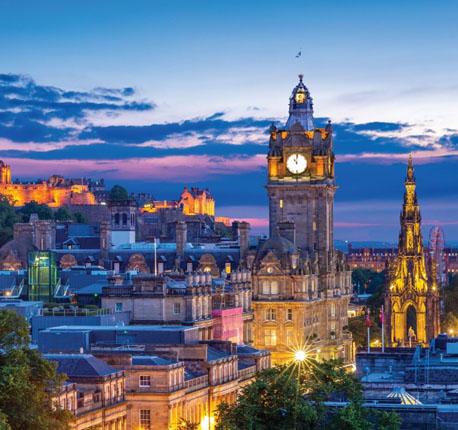 View of Edinburgh, Scotland featuring the Balmoral Hotel Clock Tower and Edinburgh Castle at Sunset