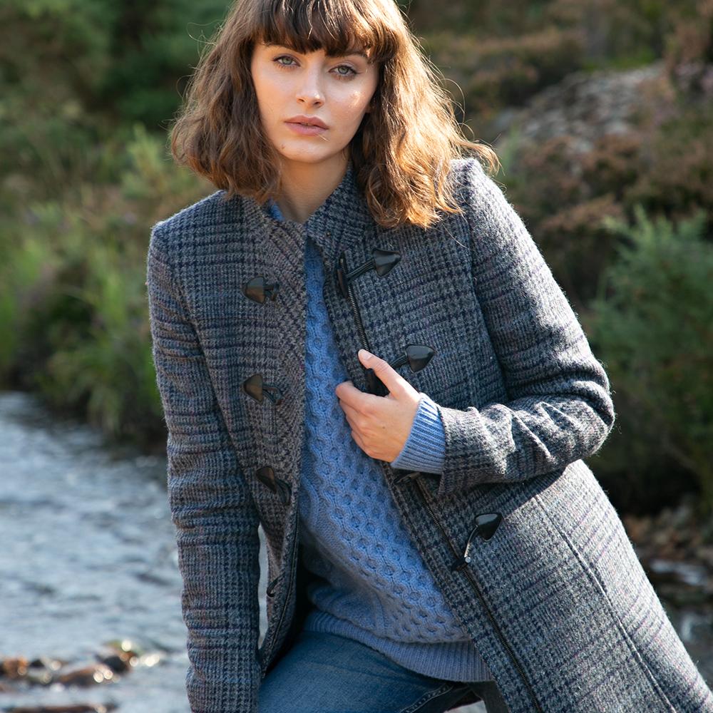 A woman in a navy duffle coat