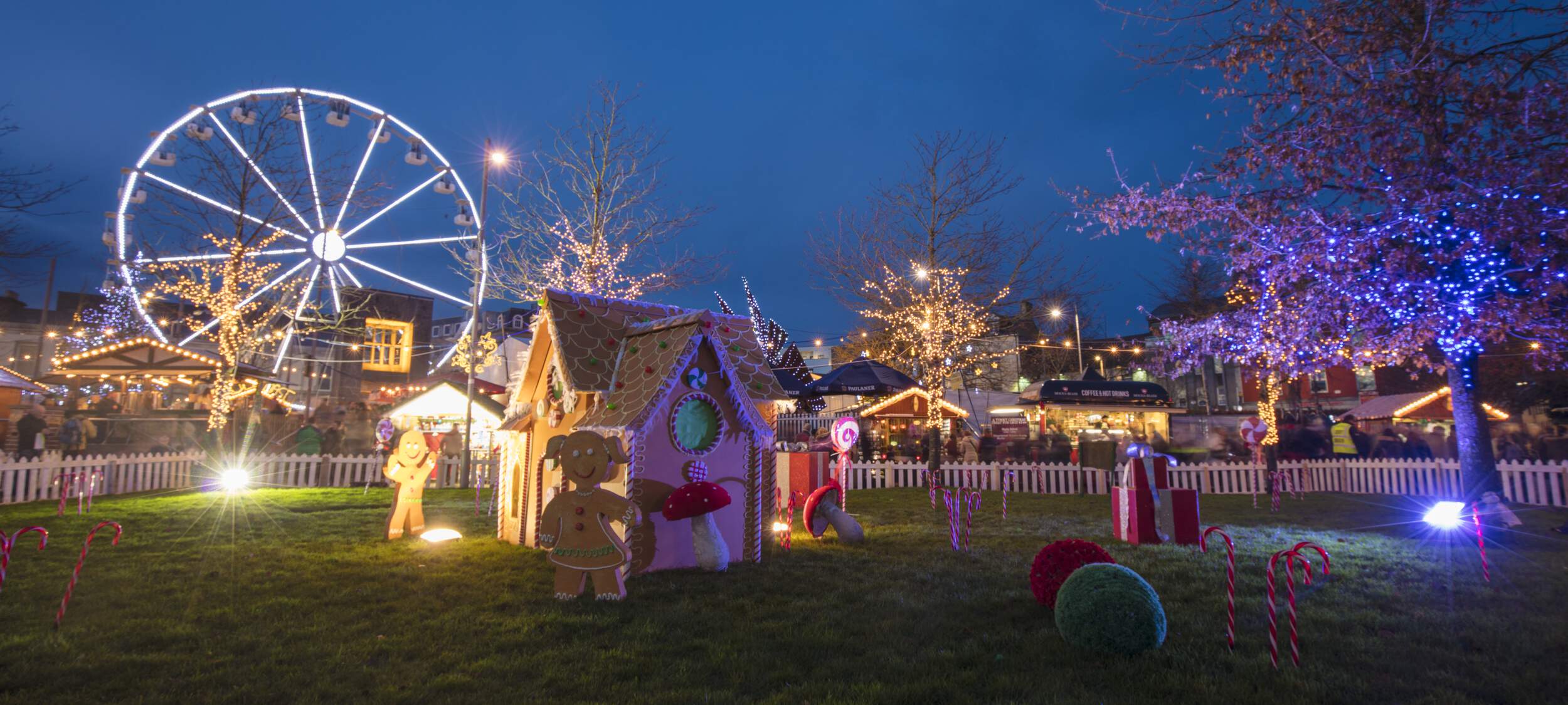The festive market of Galway, with lights and stalls and amusement rides