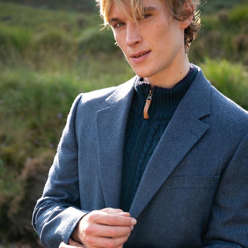 A man wearing a blue tweed jacket