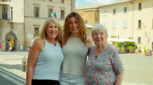 Three CIE Tours travelers smiling together on vacation