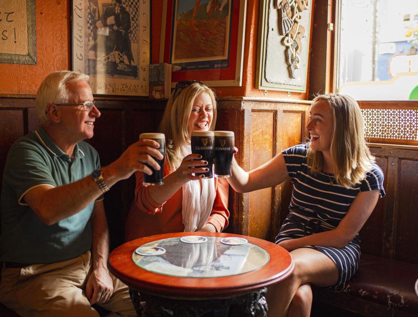 Family raising a few pints in an Irish pub