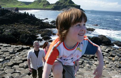 Child climbing along Giant's Causeway